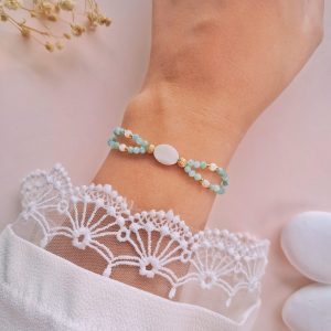 Bracelet amazonite et nacre Clara porté au poignet avec détails dorés
