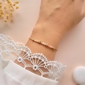 Bracelet fin rose et doré Lina n°2 porté au poignet avec perles d’opale rose et détails texturés