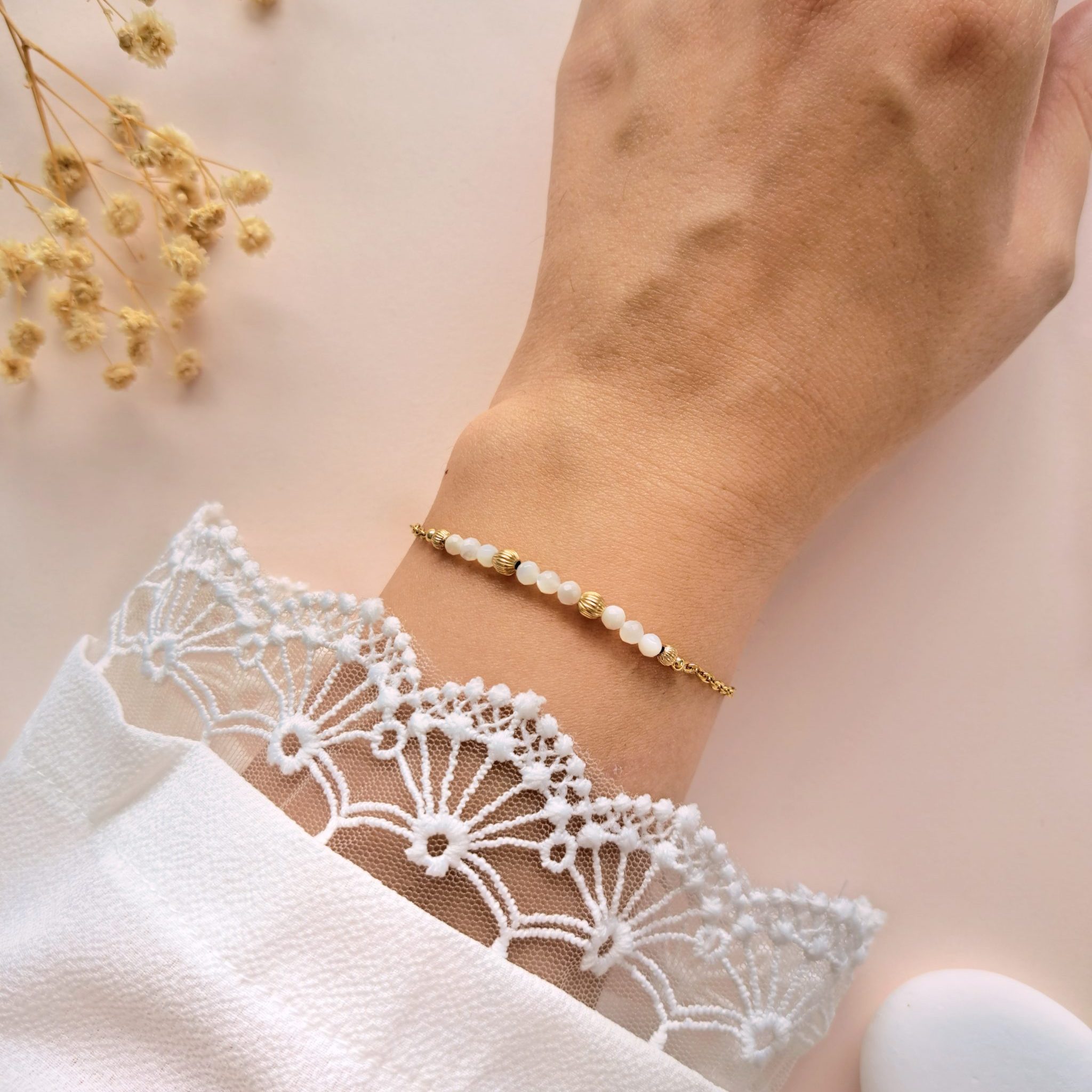 Bracelet nacre perles dorées Gabrielle n°2 porté au poignet avec détails dorés texturés